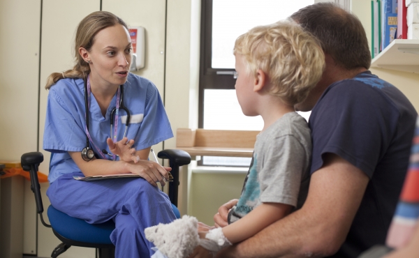 Doctor speaking with child and parent